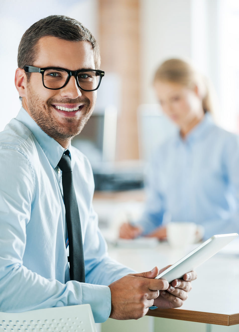 professional male wearing a tie looking at the camera and smiling